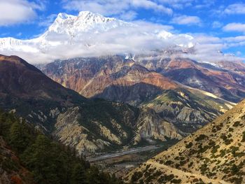 Scenic view of mountains against cloudy sky