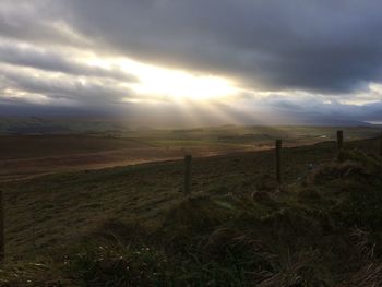 Scenic view of landscape against dramatic sky