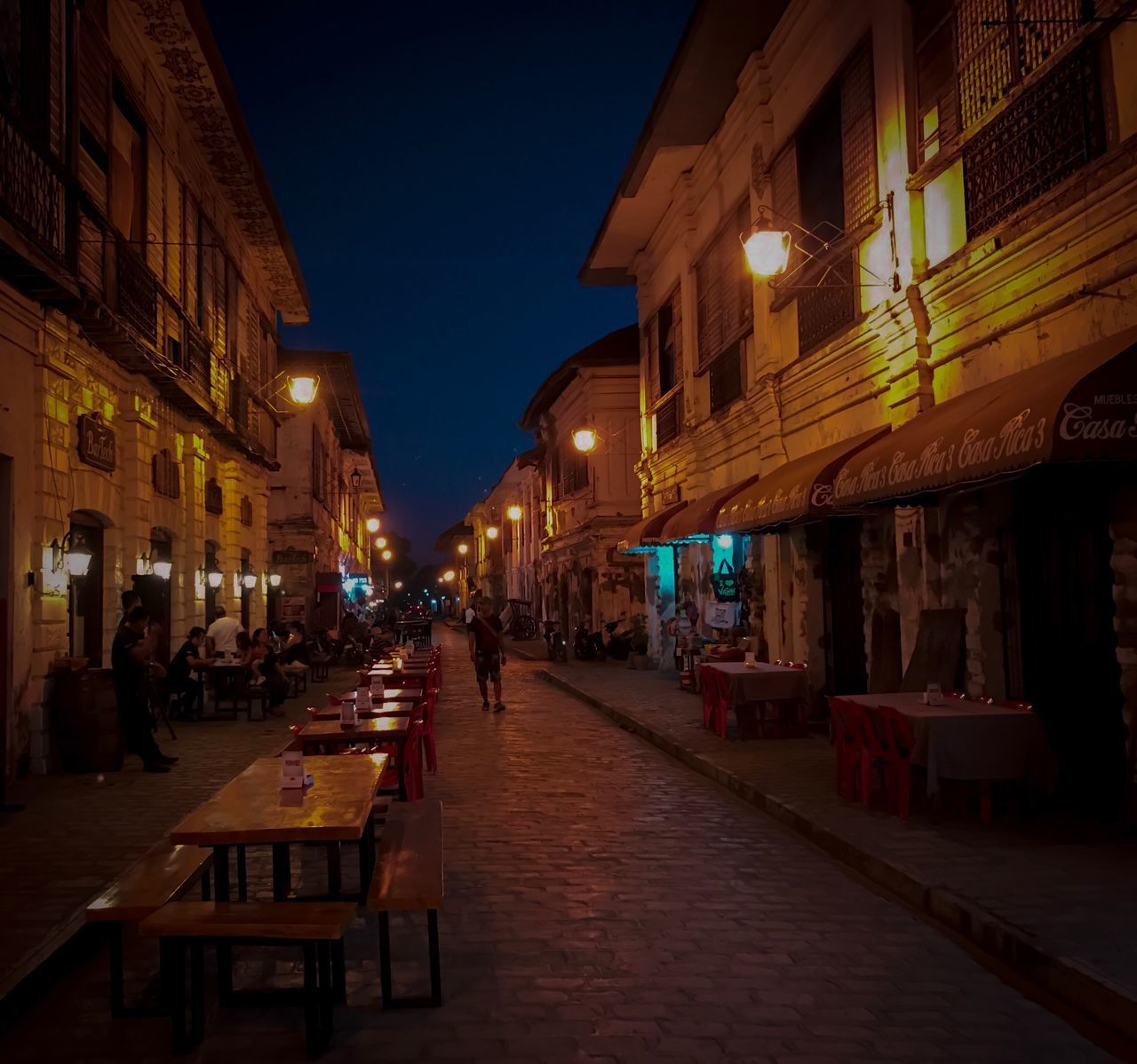 VIEW OF ILLUMINATED STREET AT NIGHT