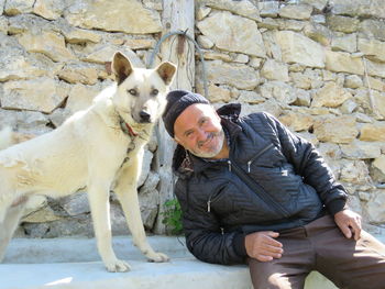 Rear view of man with dog on field