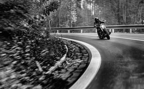 Man riding motorcycle on road