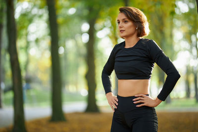 Young woman standing against blurred background