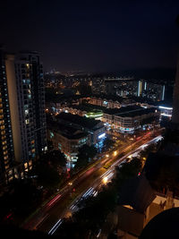 High angle view of illuminated cityscape against sky at night