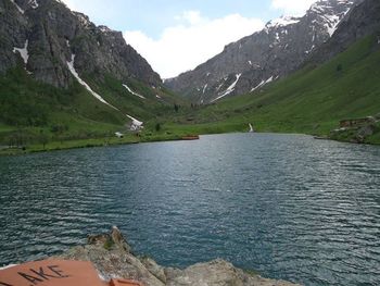 Scenic view of river and mountains against sky