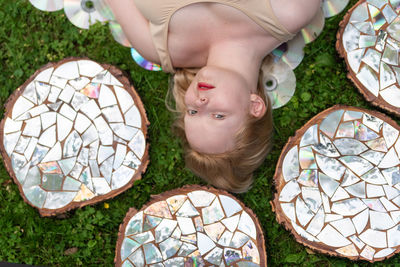 High angle view of woman laying on field