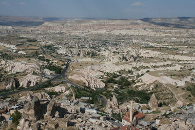 High angle view of land and mountains against sky