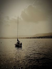 Sailboat sailing on sea against sky