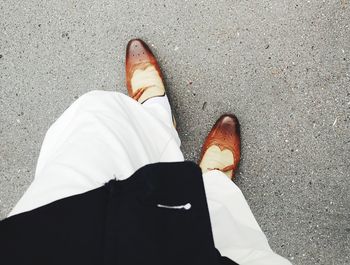 Low section of person standing on road