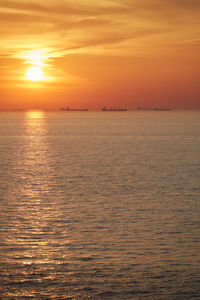 Scenic view of sea against romantic sky at sunset