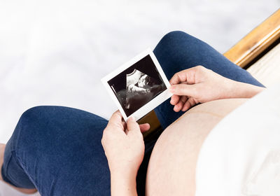 Midsection of couple holding hands