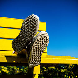 Low section of person standing on wooden bench