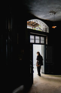 Rear view of man walking in tunnel