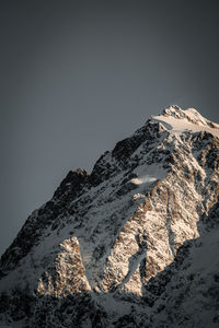 Scenic view of snowcapped mountains against clear sky