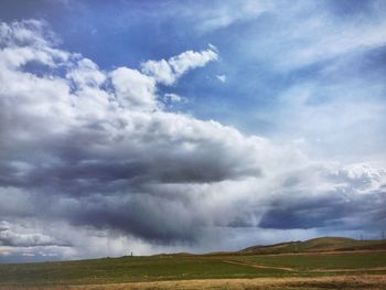 Scenic view of landscape against cloudy sky