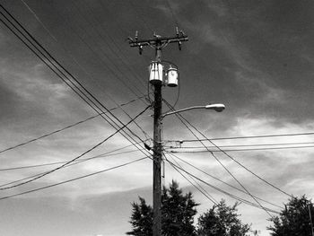 Low angle view of electricity pylon against sky