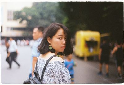 Portrait of woman looking at city street