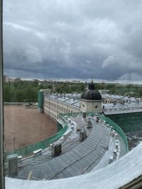 High angle view of buildings against cloudy sky