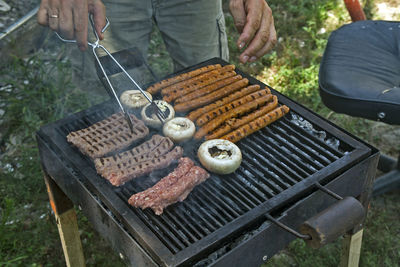 Preparing barbecue meat at picnic in nature. the meat is roasted in a conventional way.