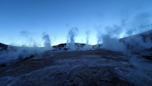 Panoramic view of people on snow covered landscape