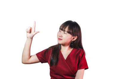 Mid adult woman standing against white background