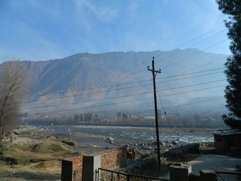 Scenic view of mountains against blue sky