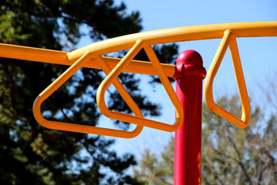 Low angle view of yellow monkey bars at playground