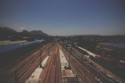 High angle view of railroad tracks in city against clear sky