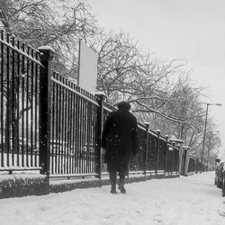 Woman standing on snow covered landscape