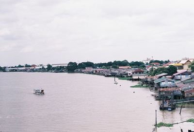 View of buildings and sea against sky