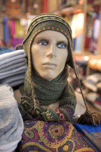 Close-up of baby wearing hat at store