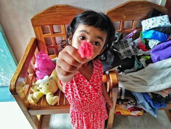 Portrait of girl holding indoors