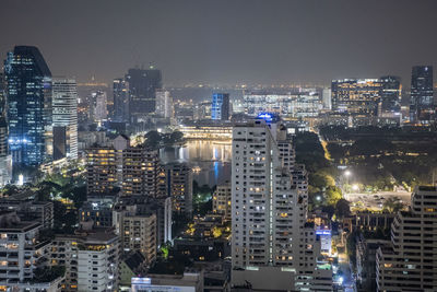 High angle view of city lit up at night