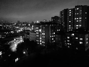 Illuminated cityscape against sky at night