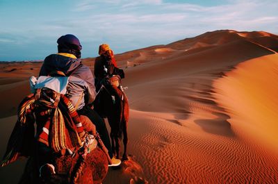 Rear view of people in desert