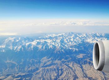 Aerial view of snowcapped mountains against sky