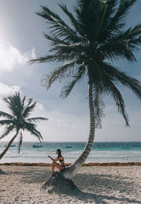 Young man standing on beach against sea