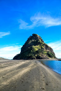 Scenic view of beach against blue sky