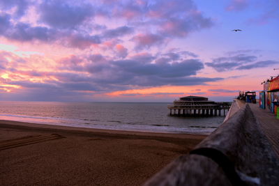 Scenic view of beach against sky during sunset