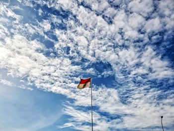 Low angle view of flag against sky