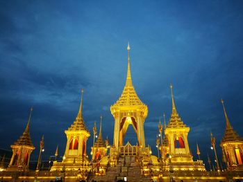 Illuminated temple against sky at dusk