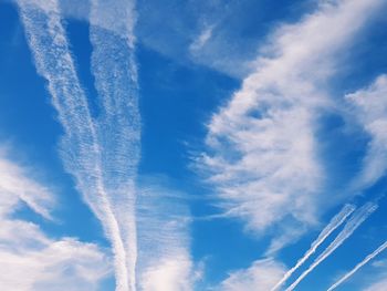 Low angle view of vapor trail against blue sky