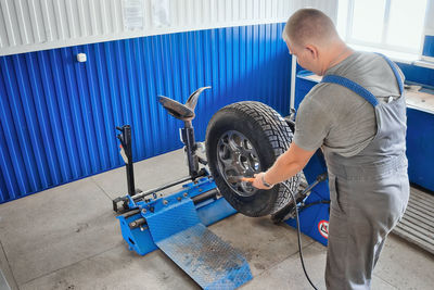 Side view of man working in workshop