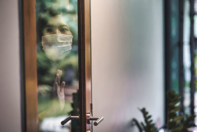 Portrait of man seen through glass window