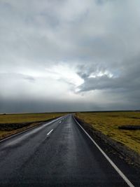 Road passing through landscape against sky