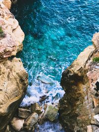 High angle view of rocks by sea