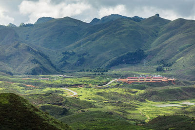 Scenic view of agricultural field and mountains against sky