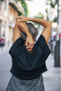 Rear view of woman standing on street