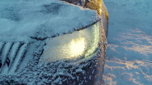 Close-up of frozen sea against snowcapped mountain