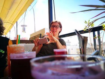 Woman sitting on table at restaurant