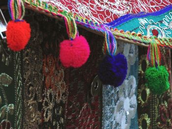 Close-up of multi colored paint hanging on wall